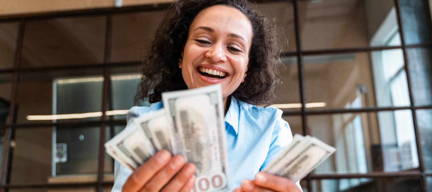 Woman counting bills in an office