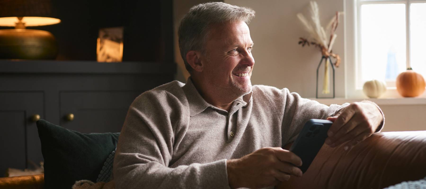 Older man at home on the couch with a blanket