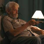 Bored retiree watching TV.