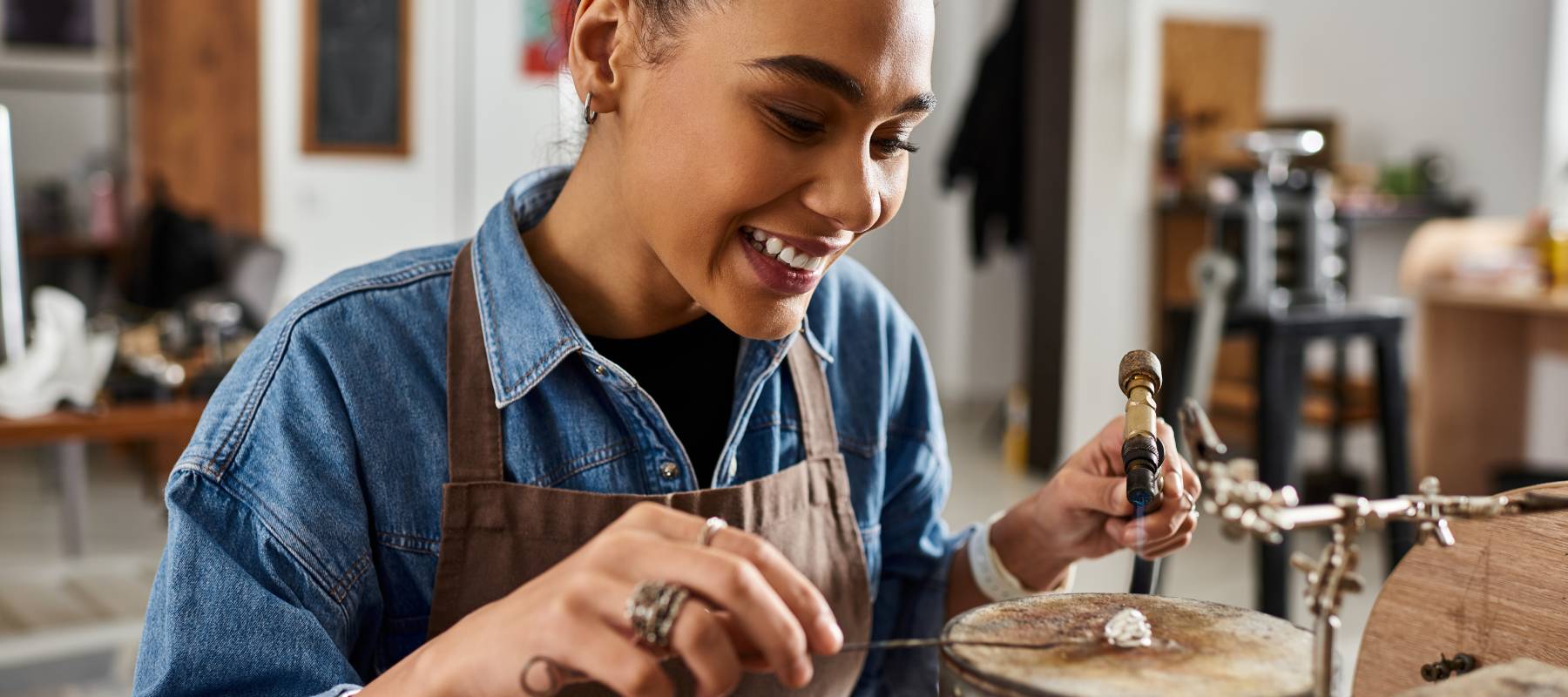 An artisan crafting jewelry in a workshop.