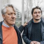 Senior man and adult son standing outside