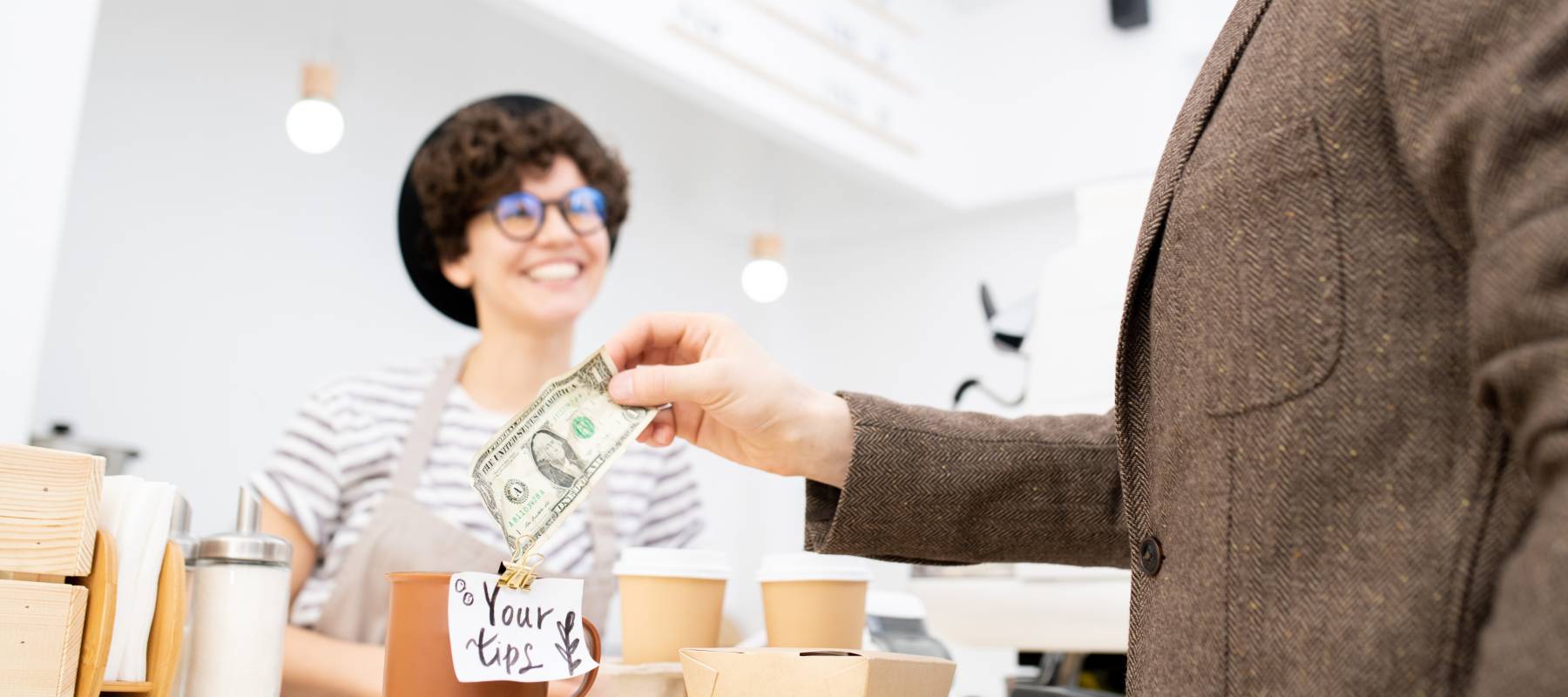 Barista getting a tip from a customer