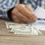 Man hands with bills and money