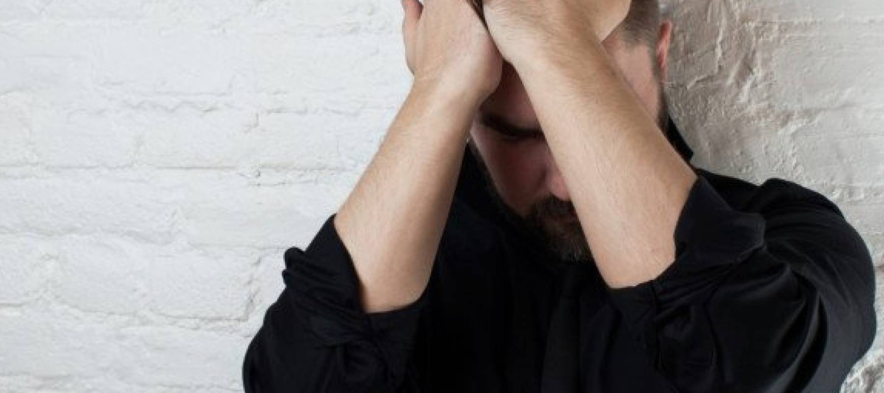 Man with hands on head in distress