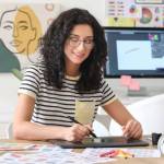 Young female designer working in office