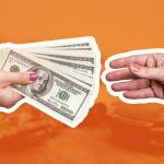 Macro focus on female hands with dollar upon crashed car