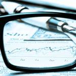 financial chart near dollars seen by unfocused glasses
