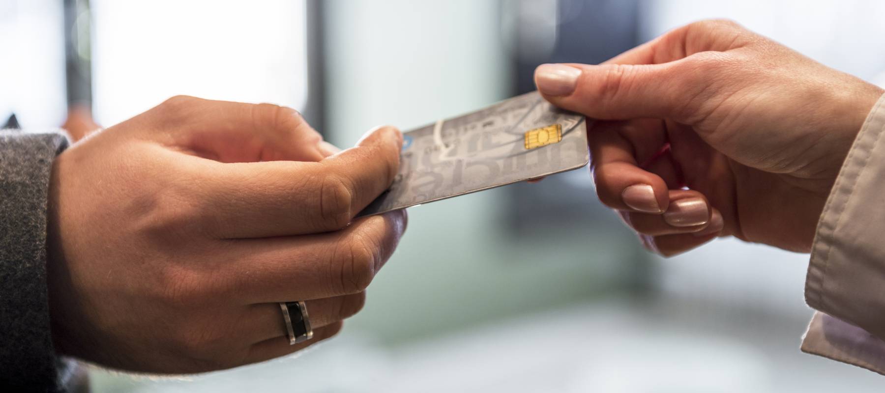 Hand giving credit card