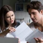 Couple looks at utility bill.