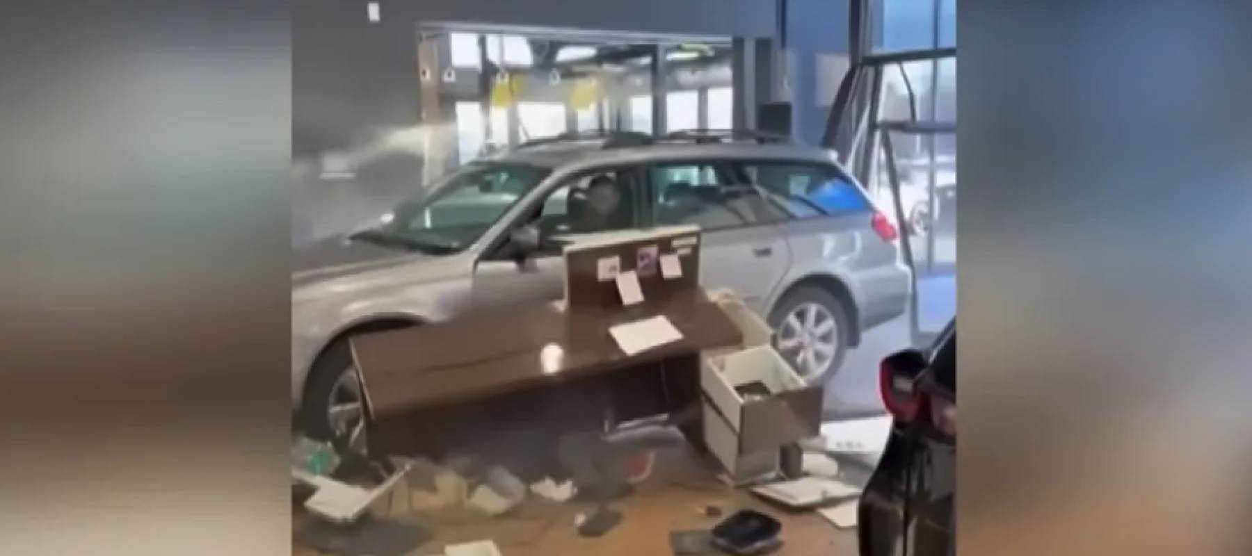 Man drives car through dealership showroom