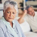 Frustrated senior couple, fight and divorce in conflict, argument or disagreement on living room couch.