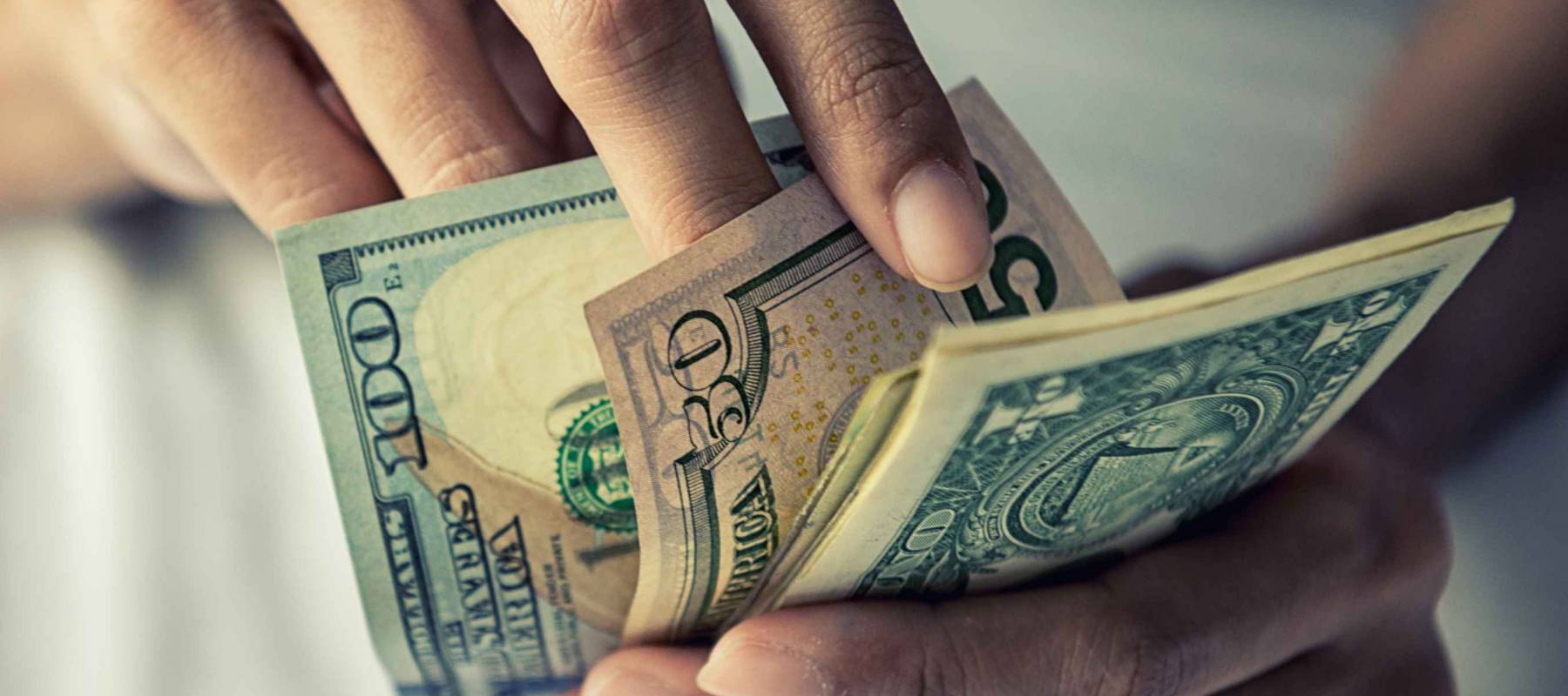 Close-up Hands counting money American dollars , Counting money American dollars with hand , Vintage tone effect , Income and Business concept.