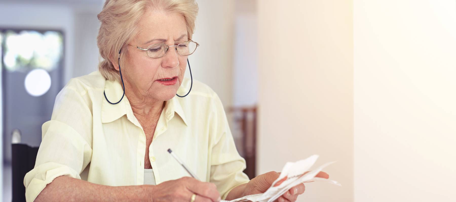 Woman going over receipts in the kitchen