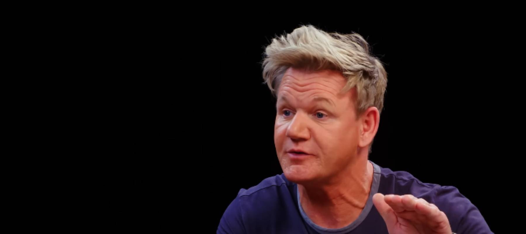Gordon Ramsay seen speaking, holding hand up and gesturing, looking to side of the camera.
