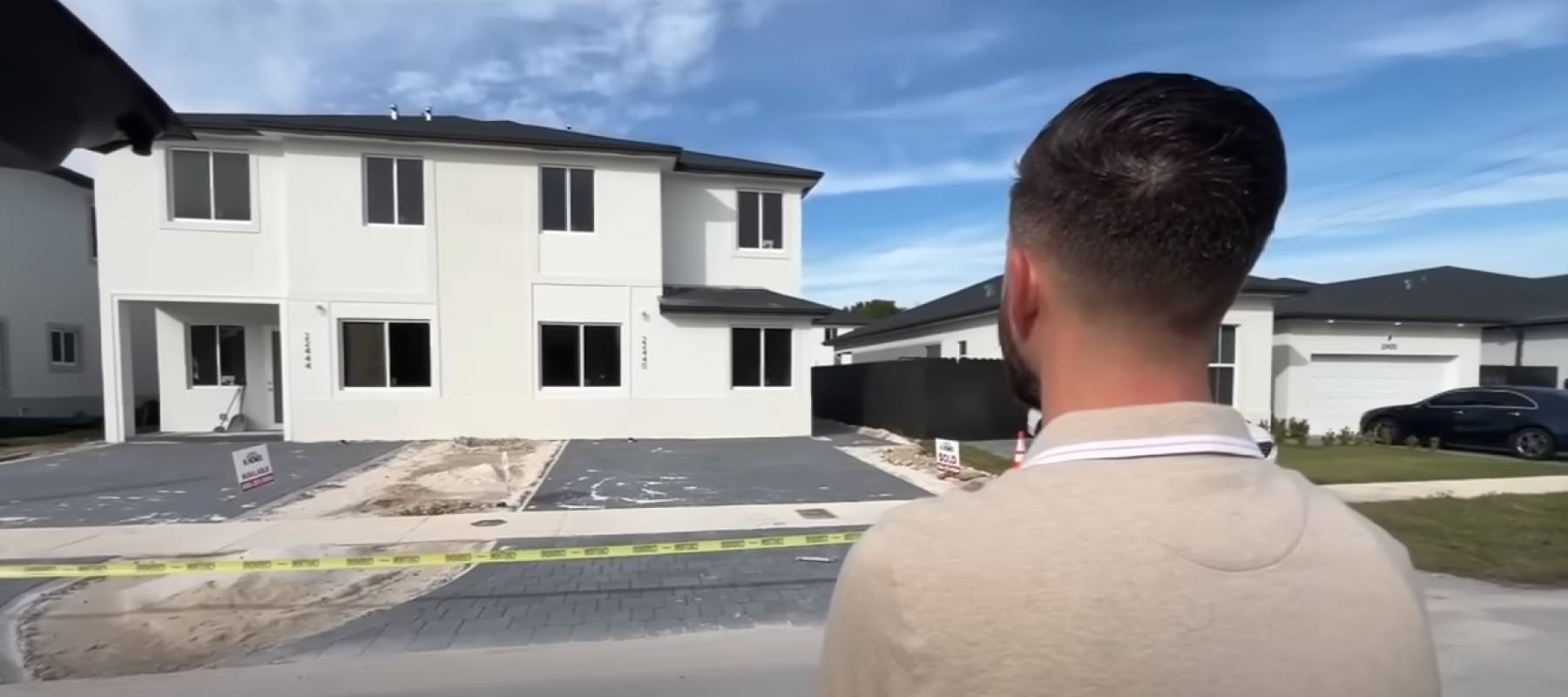 Man stands outside of new build home