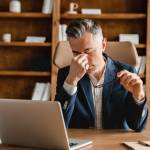Man stressed out on his computer