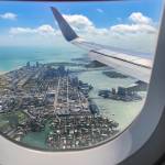 Image of Miami Beach seen from above through window of plane.