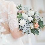 Wedding floral table decoration with candles in transparent vases