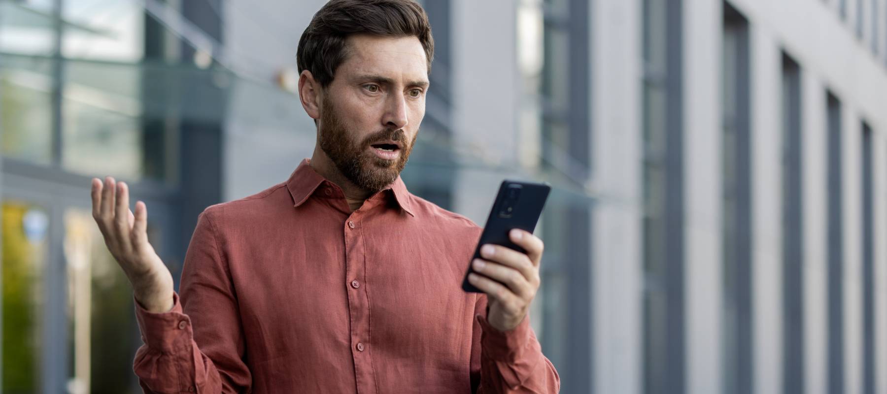 Man looking at his phone concerned