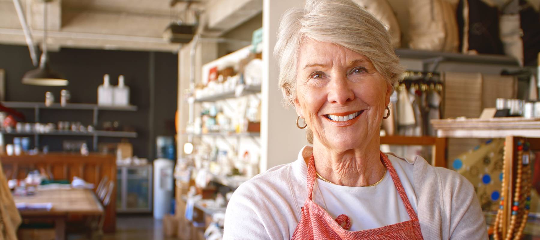 An older woman working at a shop.