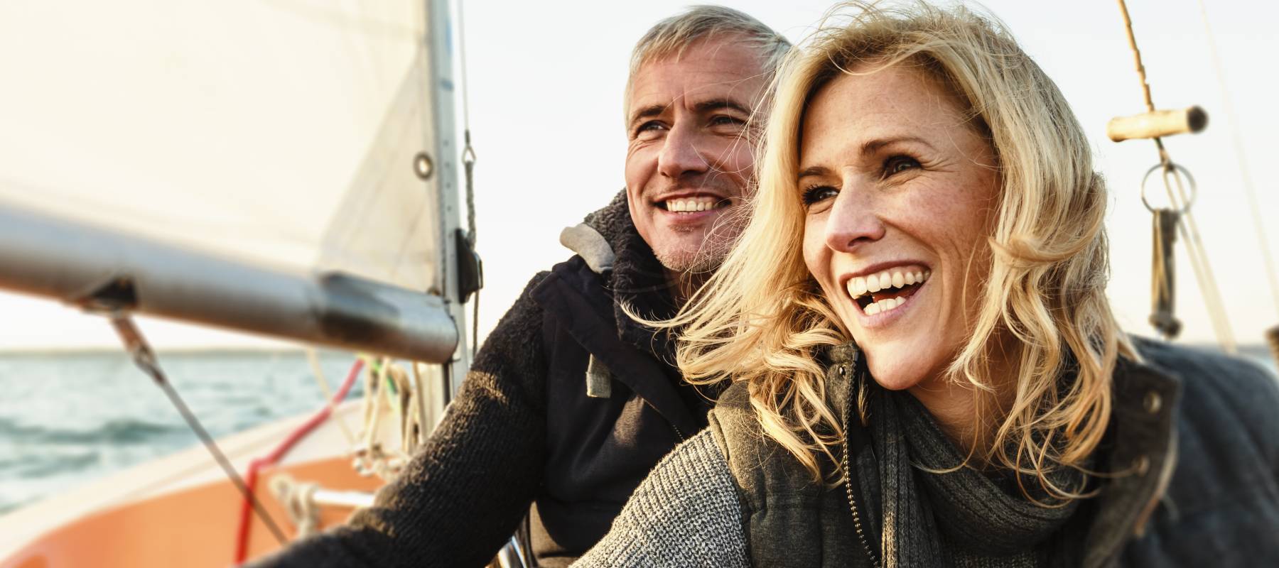 A couple enjoying their day sailing on the water.