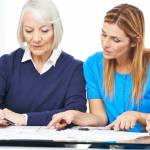 Woman consulting senior couple in nursing home
