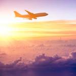 Airplane in the sky at sunrise