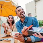 Couple paying for meal with a debit card.