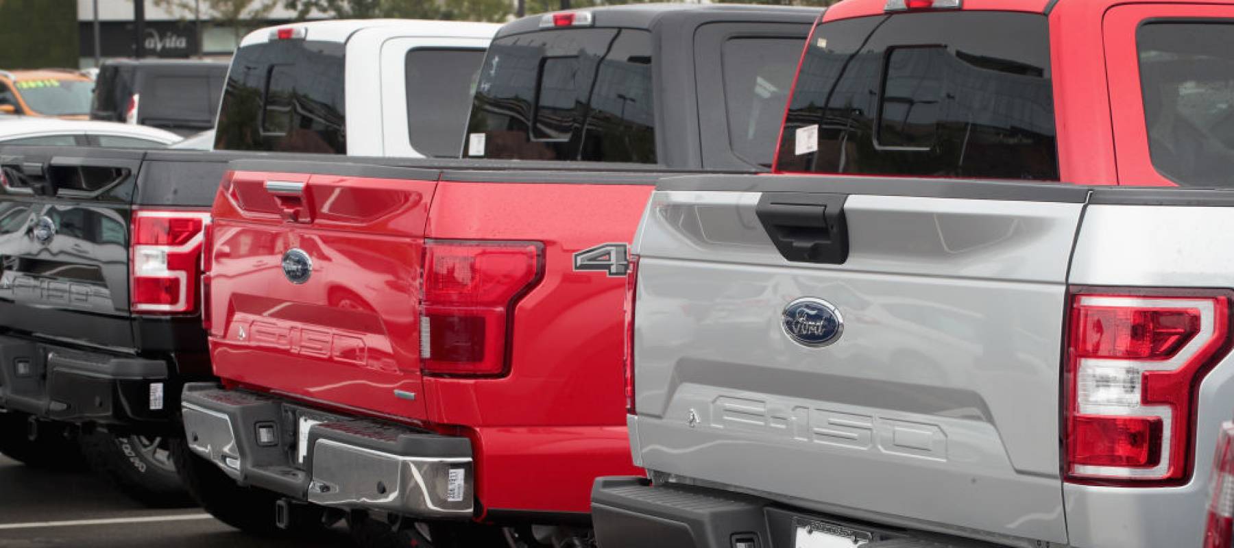 Ford pickup trucks on a dealer lot.