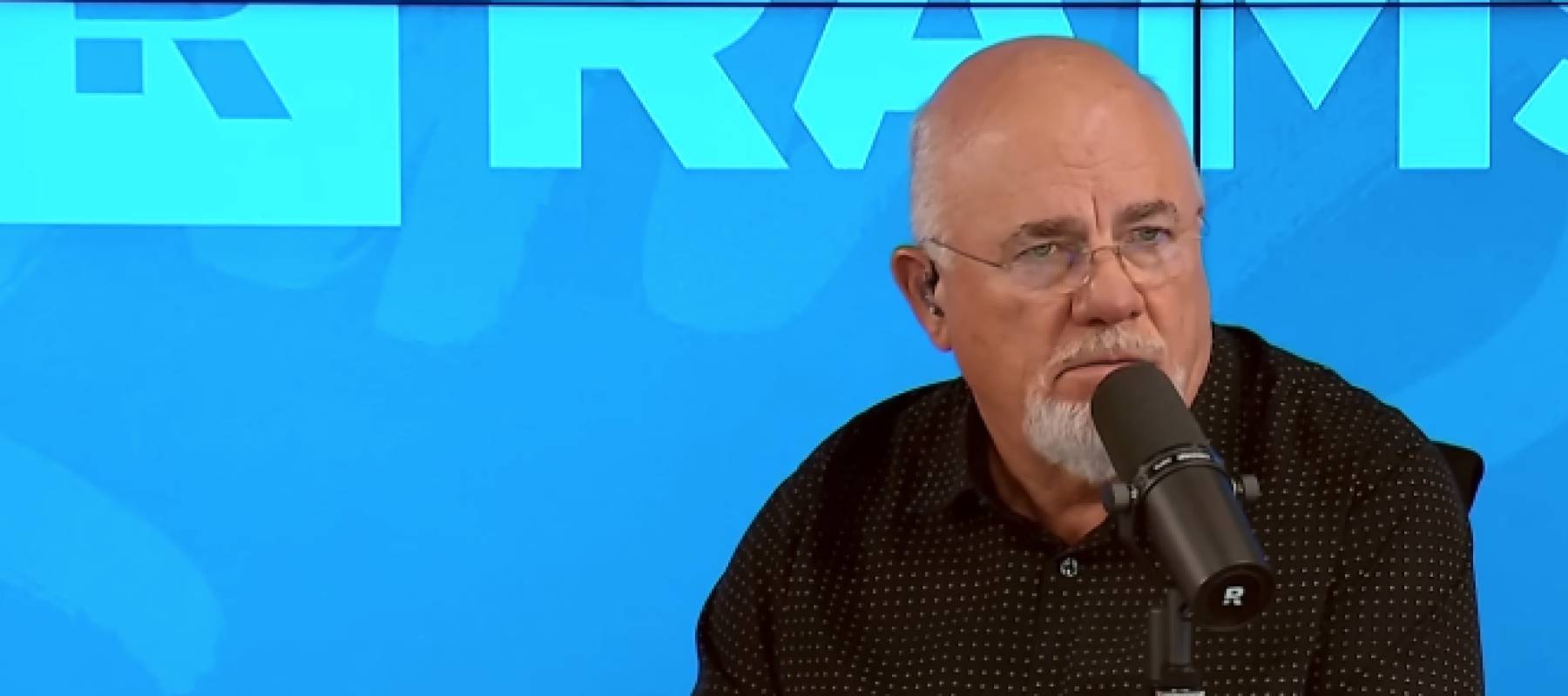 Dave Ramsey squints and looks incredulous on the set of his radio show.