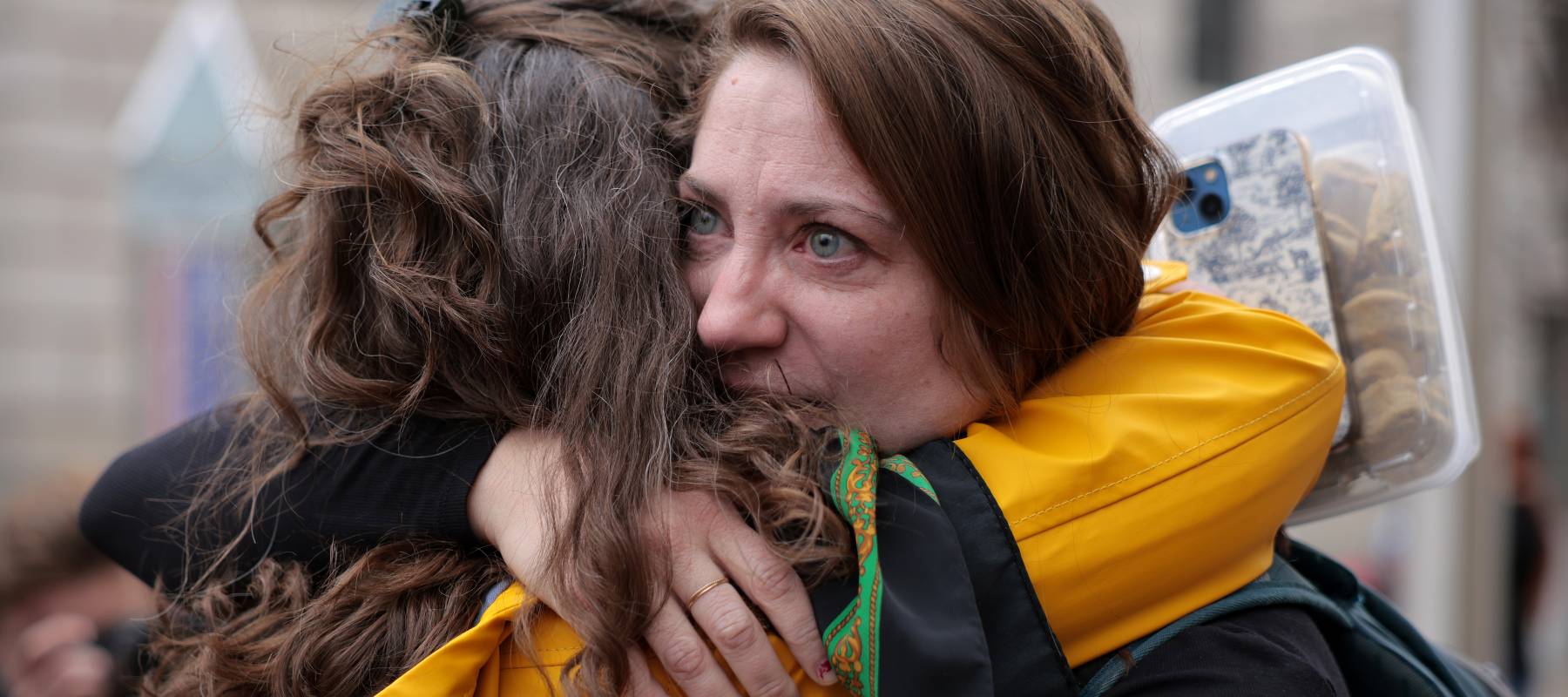 A U.S. Agency for International Development worker is embraced after arriving to pick up her belongings from the office in Washington, D.C., Feb. 27, 2025.