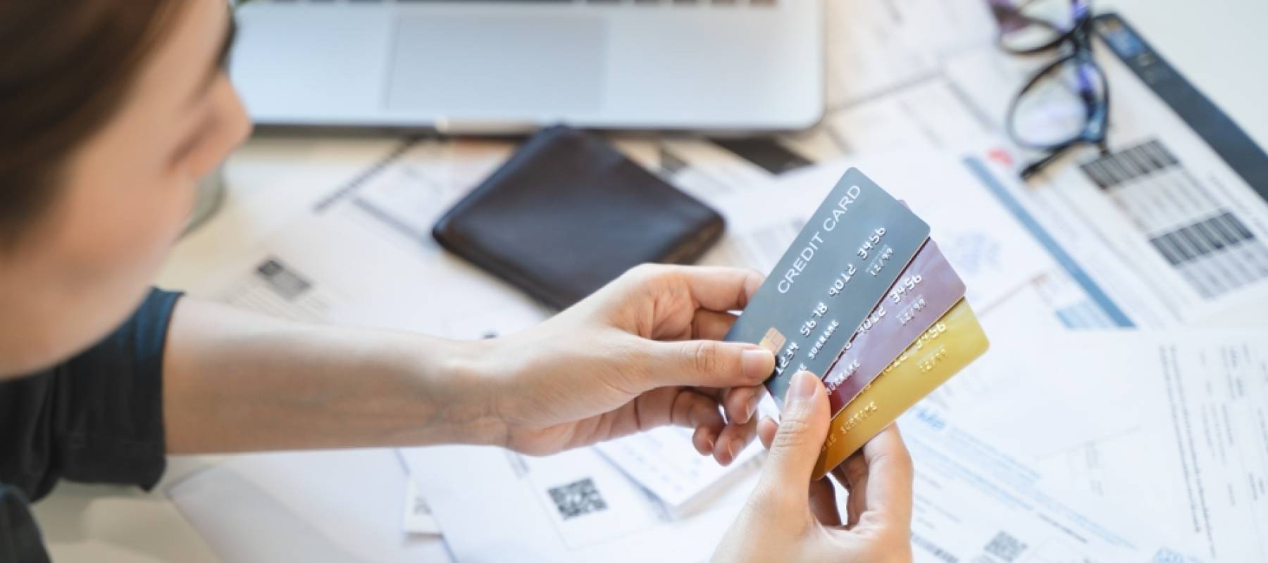 Woman looking at credit cards