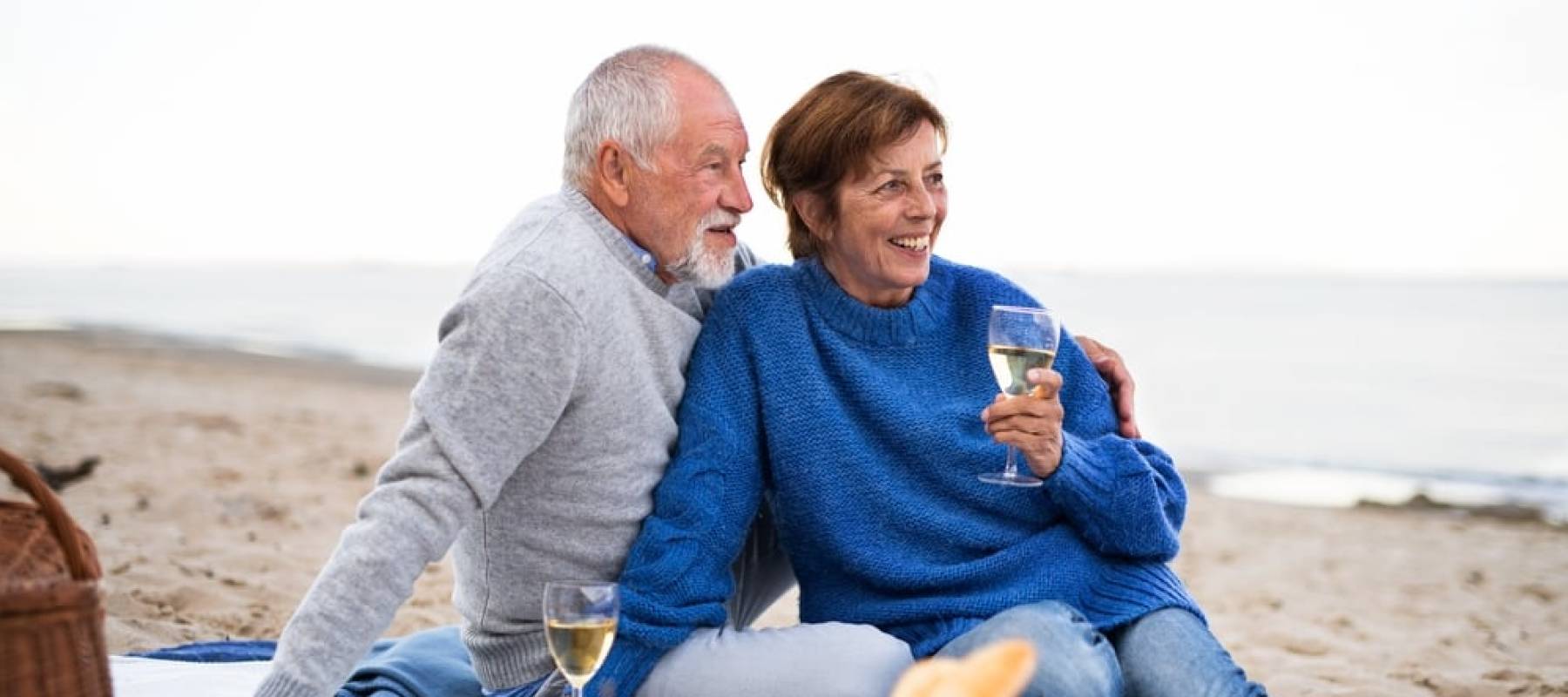 Happy senior couple in love sitting on blanket