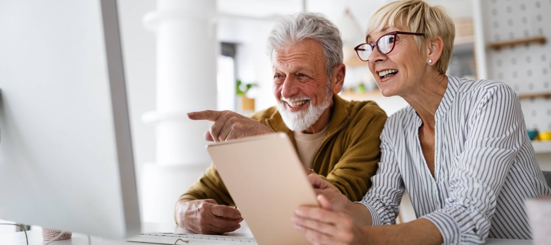 Elderly couple looking at a computer