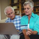Couple looking at their credit card statements online