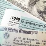 Image of tax-related forms and check.