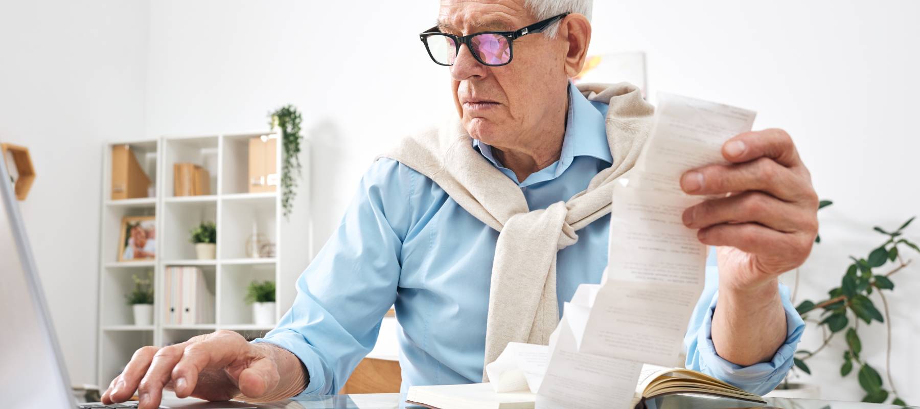 Senior man looking at bills