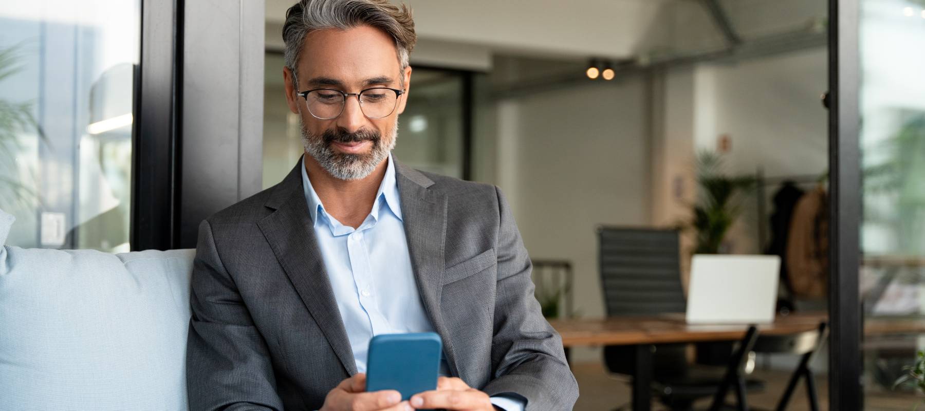 Middle-aged man looking at phone.
