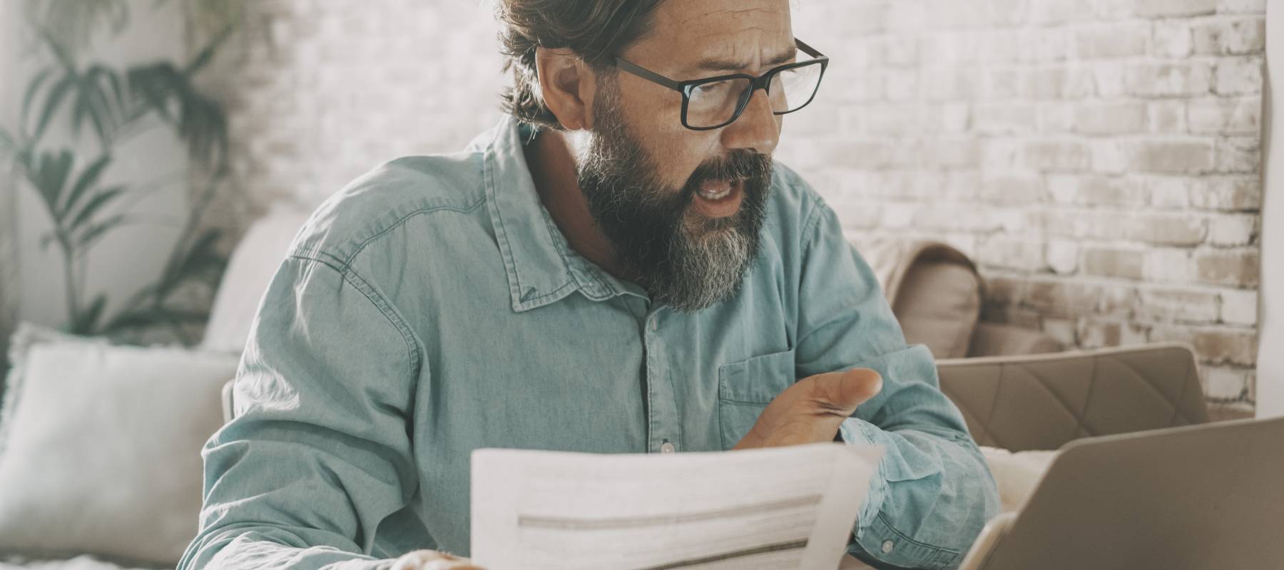 Older man looking at bills