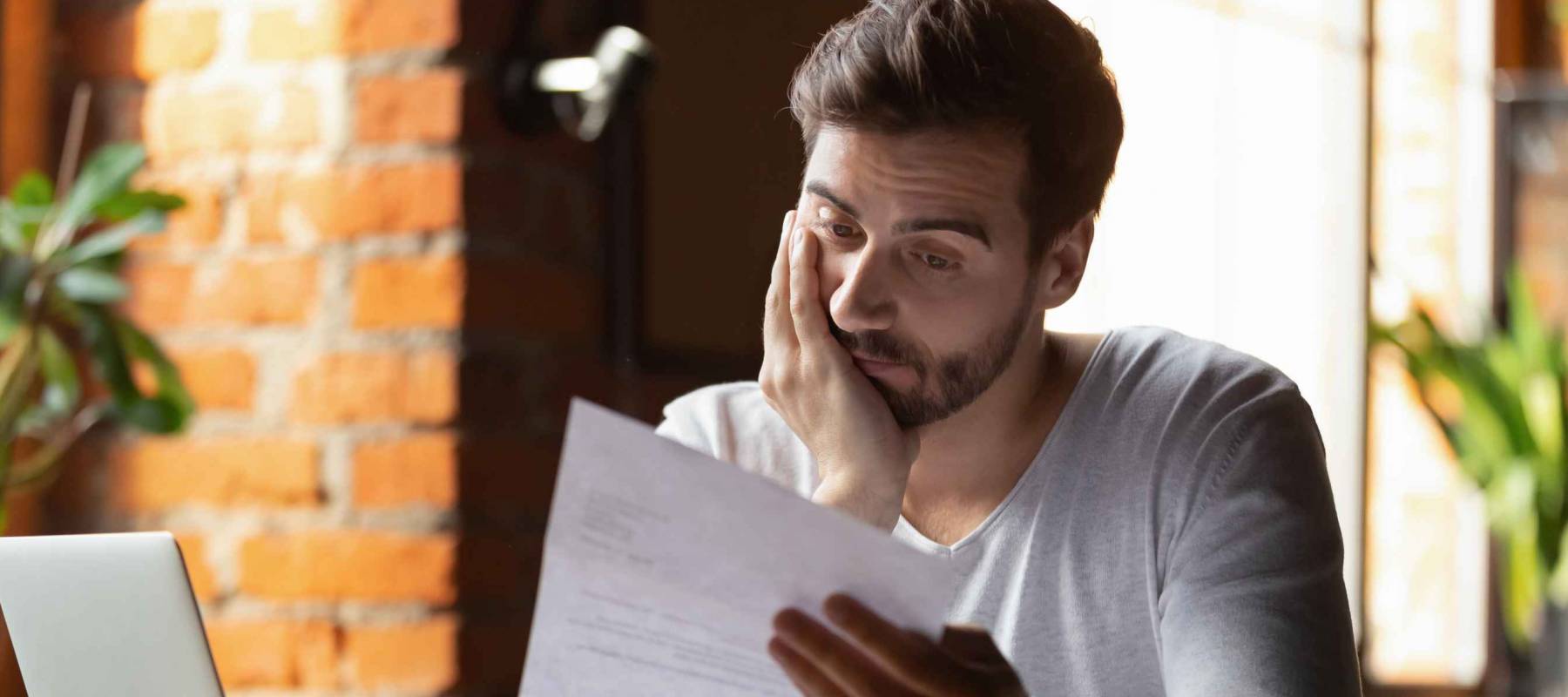 Frustrated job seeker looking at resume