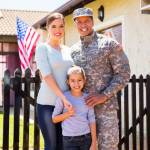 happy american soldier reunited with family outside their home