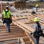 A group of workers construct a house at a Habitat for Humanity site in Houston, Texas, Dec. 16, 2024.