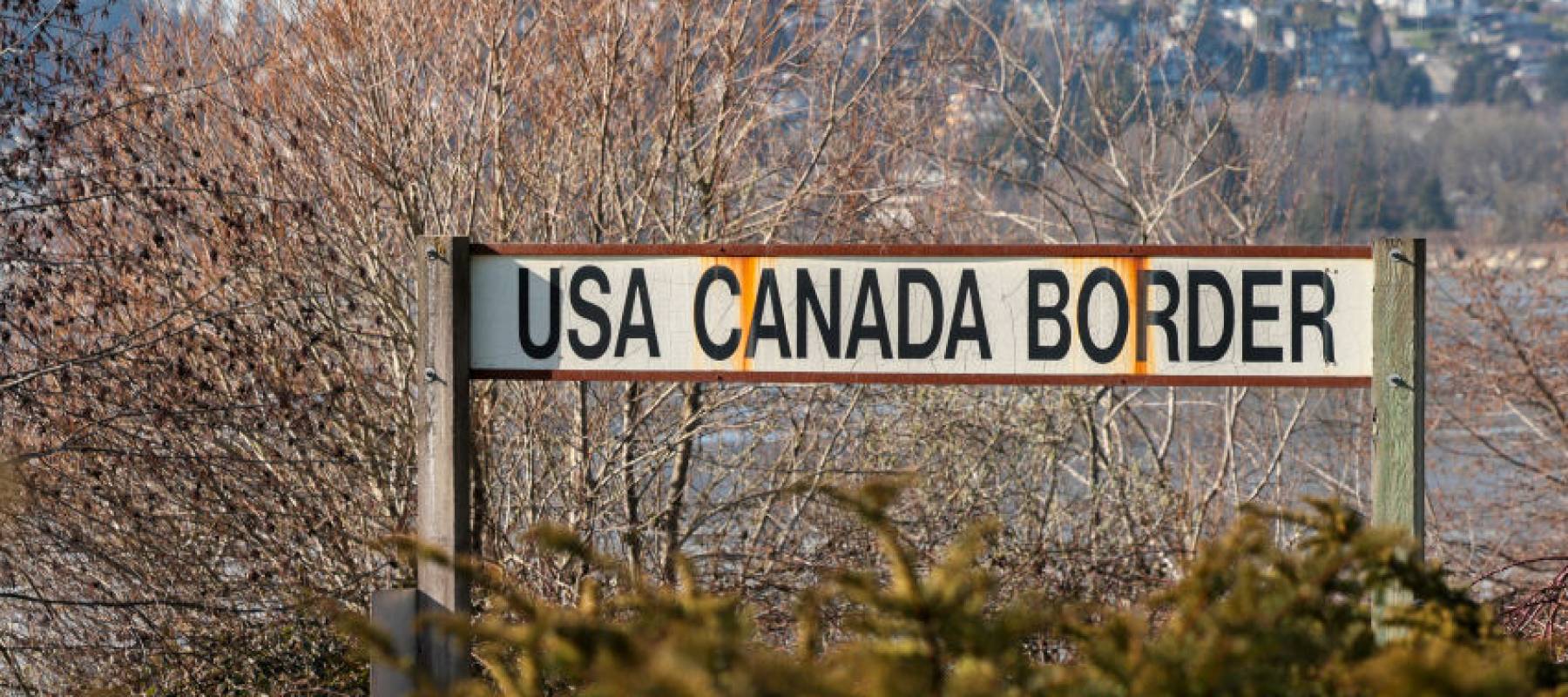 A U.S.-Canada border sign.