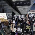 People protesting outside of a Tesla dealership in New York