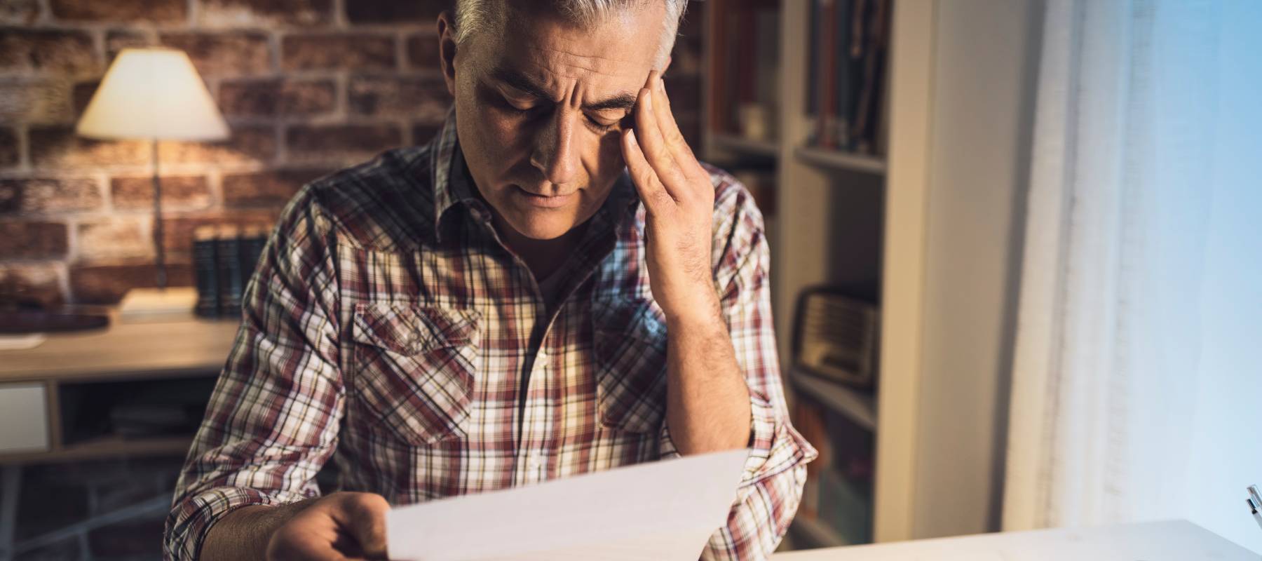 Worried mature man checking his bills.