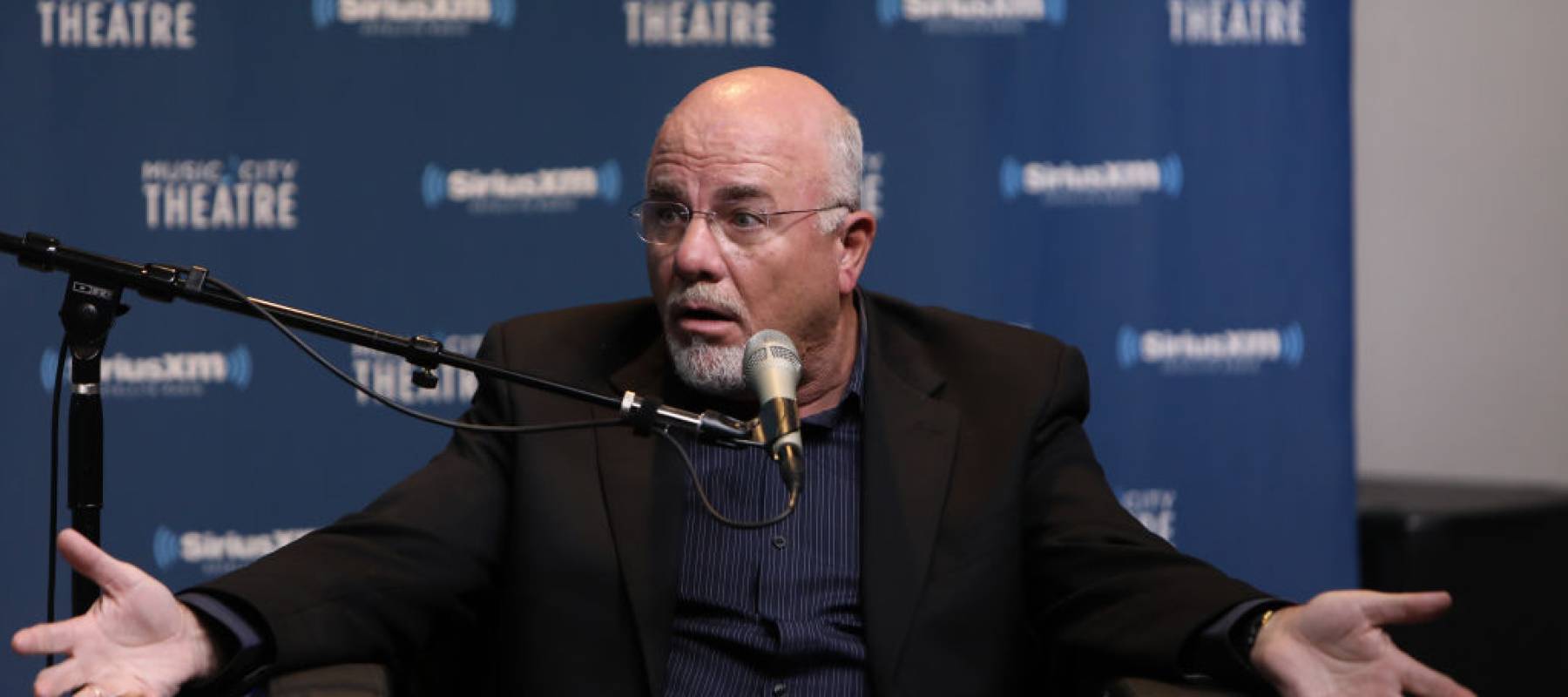 A still of Dave Ramsey speaking on set of his radio show.