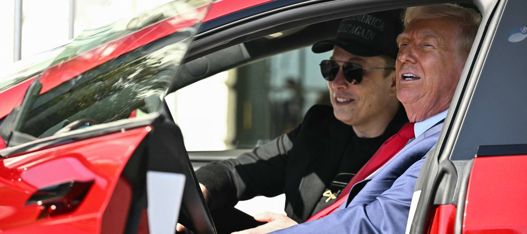 US President Donald Trump and Tesla CEO Elon Musk speak to the press as they sit in a Tesla vehicle on the South Portico of the White House on March 11, 2025 in Washington, DC.