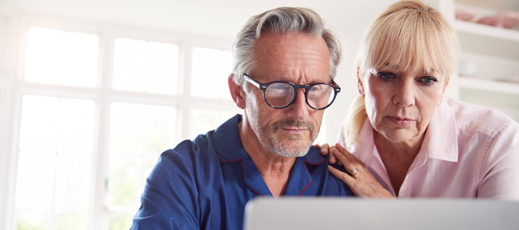 Elderly couple looking at the computer