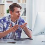 Frustrated man looking at his computer