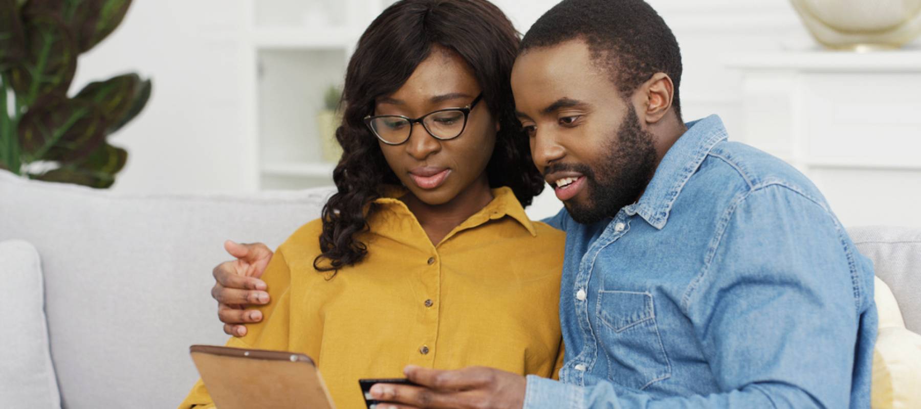 Couple looking at a tablet.